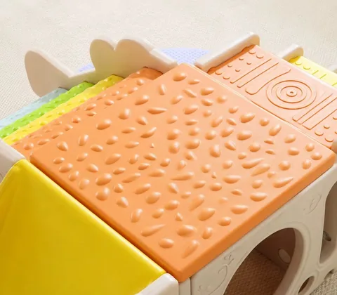 Acercamiento de la plataforma naranja con relieves y de los rodillos con textura del escalador