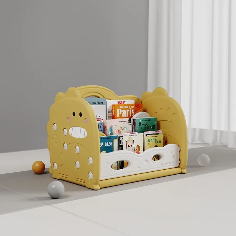 Librerito de piso amarillo con laterales en forma de dinosaurio sonriente y cuentos de frente en tres filas